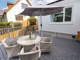 An outdoor patio with a table and chairs at Pinecroft Annex Stepaside near Saundersfoot