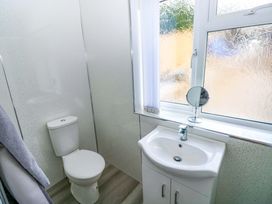 A bathroom with a sink and toilet at Pinecroft Annex Stepaside near Saundersfoot