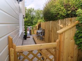 An outdoor area with a table and chairs at Pinecroft Annex Stepaside near Saundersfoot