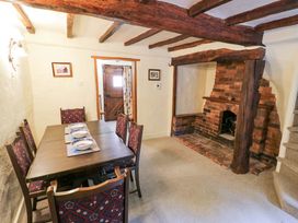 A dining room with a table and chairs at Fern Cottage in 