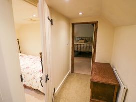 A hallway with two doors leading to bedrooms at Fern Cottage
