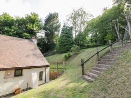 A garden with steps leading to the house at Fern Cottage