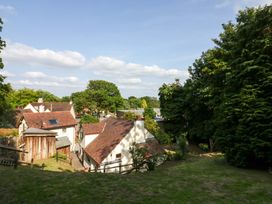 An outdoor view showing houses and trees at Fern Cottage