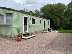 A mobile home with steps and outdoor furniture at Sylvan in Builth Wells