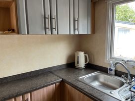 A kitchen with a kettle and sink at Sylvan in Builth Wells