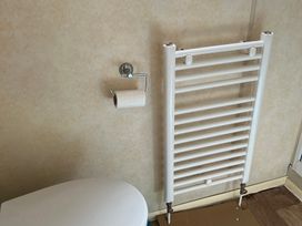 A bathroom with a toilet and a radiator at Sylvan in Builth Wells