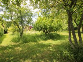 A garden with trees and grass at Uplands House in Ledbury