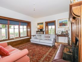 A living room with a sofa and armchair at Uplands Dowerhouse in Wellington Heath near Ledbury