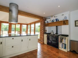 A kitchen with a stove and island at Uplands Dowerhouse in Wellington Heath near Ledbury
