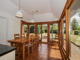 A dining room with a wooden table and chairs at Uplands Dowerhouse in Wellington Heath near Ledbury