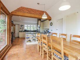 A kitchen with dining table and chairs at Uplands Dowerhouse Wellington Heath near Ledbury