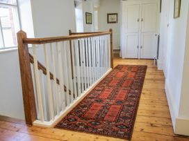 A hallway with a carpet and a staircase at Uplands Dowerhouse in Wellington Heath near Ledbury
