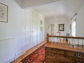 A hallway with a staircase railing at Uplands Dowerhouse Wellington Heath near Ledbury