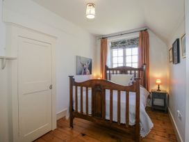 A bedroom with a bed and nightstand at Uplands Dowerhouse in Wellington Heath near Ledbury