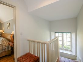 A landing with a staircase and window at Uplands Dowerhouse Wellington Heath near Ledbury