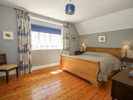 A bedroom with a bed and nightstand at Uplands Dowerhouse Wellington Heath near Ledbury