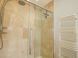 A bathroom with a shower and towel rail at Uplands Dowerhouse Wellington Heath near Ledbury