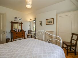 A bedroom with a bed and dresser at Uplands Dowerhouse Wellington Heath near Ledbury