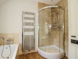 A bathroom with a shower and bathtub at Uplands Dowerhouse Wellington Heath near Ledbury