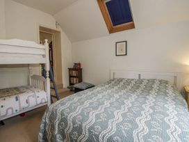 A bedroom with a bunk bed and a double bed at Uplands Dowerhouse Wellington Heath near Ledbury