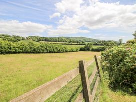 A view of a field with a wooden fence at Uplands Dowerhouse Wellington Heath near Ledbury