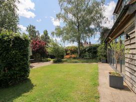 A garden with trees and grass at Uplands Cottage in Ledbury