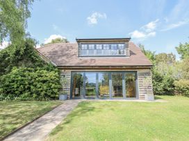 A house with large windows and a garden at Garden Cottage Wellington Heath near Ledbury