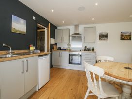 A kitchen with a sink and stove at Garden Cottage Wellington Heath near Ledbury