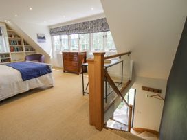 A bedroom with a bed and a bookshelf at Garden Cottage in Wellington Heath near Ledbury
