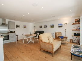 A living room with a dining table and kitchen area at Garden Cottage Wellington Heath near Ledbury