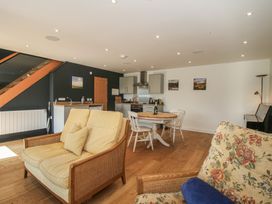 A living room and kitchen area with furniture at Garden Cottage in Wellington Heath near Ledbury