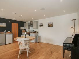 A kitchen with a table and chair at Garden Cottage Wellington Heath near Ledbury