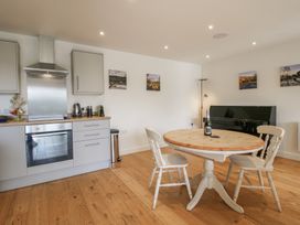 A kitchen with a dining table and chairs at Garden Cottage in Wellington Heath near Ledbury