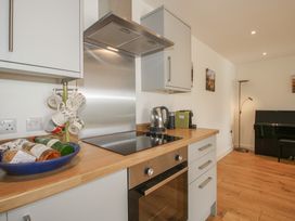A kitchen with oven, kettle, and cooking items at Garden Cottage in Wellington Heath near Ledbury