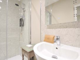 A bathroom with a shower and sink at Evelyn in Looe