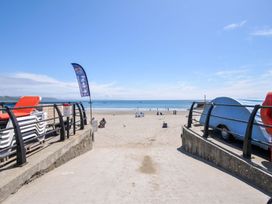 A beach with chairs and a cafe at Evelyn in Looe