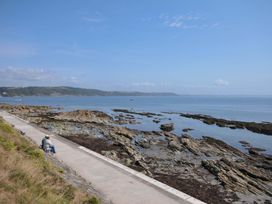 A person sitting by the shoreline at Evelyn in Looe