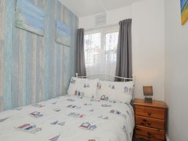 A bedroom with a bed and bedside table at 13 Hillside, Bude