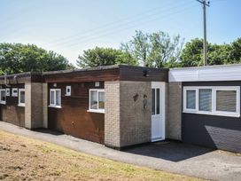 A bungalow exterior with door and windows at 13 Hillside in Bude