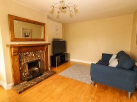 A living room with a fireplace and television at 51 Woodview Park in Tralee, County Kerry