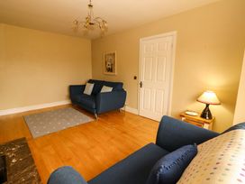 A living room with a sofa and a lamp at 51 Woodview Park Tralee, County Kerry