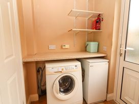 A laundry room with a washing machine and freezer at 51 Woodview Park in Tralee, County Kerry