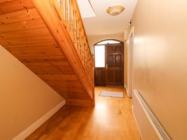 A hallway with stairs and a front door at 51 Woodview Park in Tralee, County Kerry