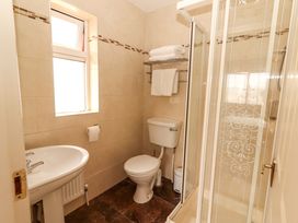 A bathroom with a shower, toilet, and sink at 51 Woodview Park in Tralee, County Kerry