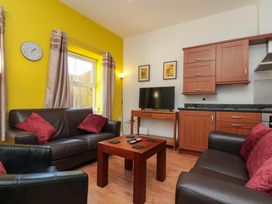 A living room with a sofa and television at Farriers Cottage in Bridlington