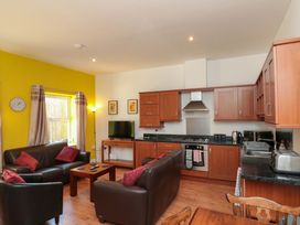 A living room with kitchen area at Farriers Cottage in Bridlington