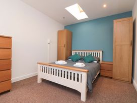 A bedroom with a bed and dresser at Farriers Cottage in Bridlington