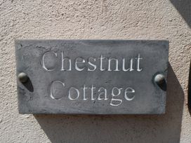 A nameplate on a wall for Chestnut Cottage
