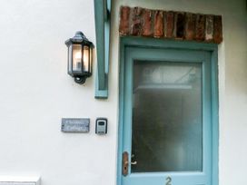 An entrance with a door and light fixture at Chestnut Cottage Bridlington