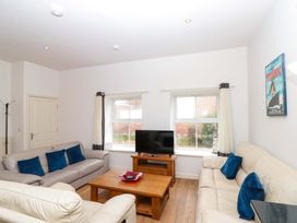 A living room with sofas and a television at Chestnut Cottage in Bridlington